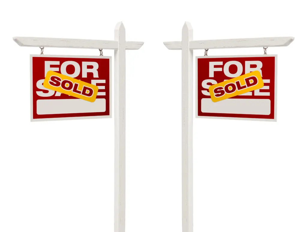 Pair of Left and Right Facing Sold For Sale Real Estate Signs With Clipping Path Isolated on White.