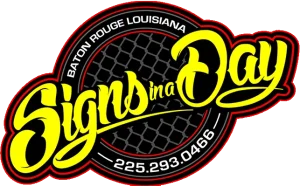 Logo for Signs by Day, a Baton Rouge, LA sign shop; yellow cursive text over a black circular emblem with a mesh pattern and phone number 225-293-0466.
